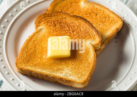 Homemade Warm Buttered Toast for Breakfast on a Plate Stock Photo