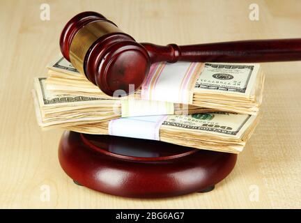 Stacks of money and judges gavel on wooden table Stock Photo