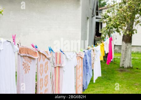 Colorful laundry hanging on rope in summer garden in typical countryside village in Ukraine Stock Photo