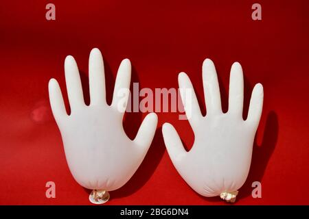 Medical gloves white color isolated on red background. protection  Stock Photo