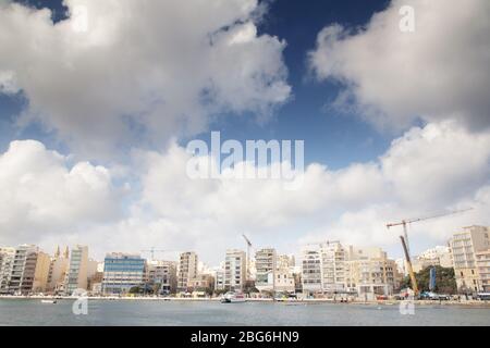 seafront along the coast of Sliema in malta with a lot of building work being done Stock Photo