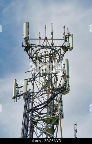 Directional mobile phone antenna aerials at the top of a mast Stock Photo