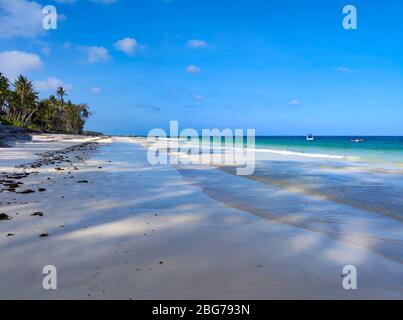 Tropical white sand beach at sunrise. Diani beach, Kenya. It is a beautiful long beach in Africa. Stock Photo