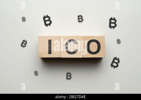 The concept of ico and cryptocurrency - wooden cubes with bitcoin. Close up. Stock Photo