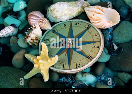 Clock on sea bottom with shells and stones Stock Photo