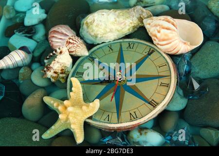 Clock on sea bottom with shells and stones Stock Photo