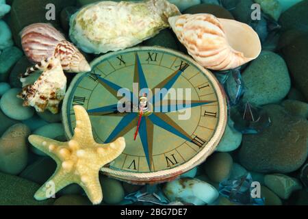 Clock on sea bottom with shells and stones Stock Photo