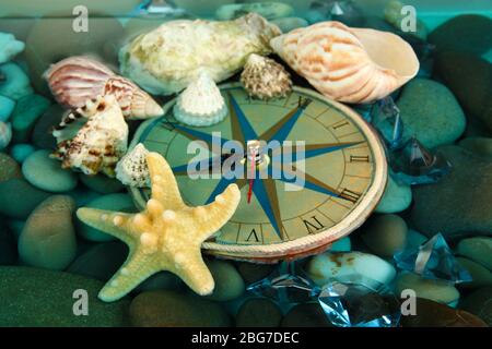 Clock on sea bottom with shells and stones Stock Photo