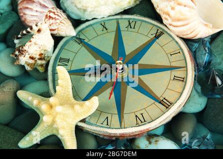 Clock on sea bottom with shells and stones Stock Photo