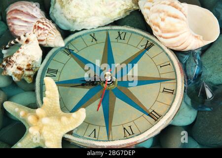 Clock on sea bottom with shells and stones Stock Photo