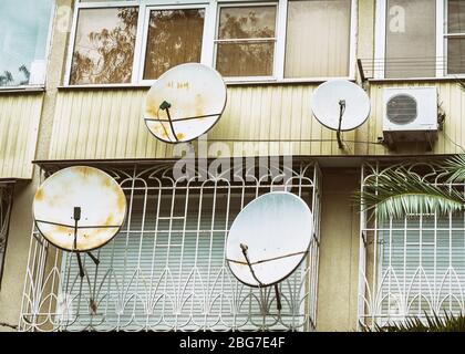 Balconies with satellite dishes and air conditioning Stock Photo