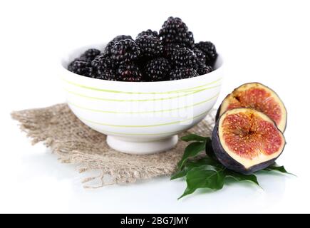 Blackberries in small bowl on sackcloth  isolated on white Stock Photo