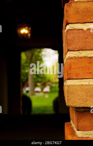 Brick Corner of Building Looking into a Dark Hallway Stock Photo