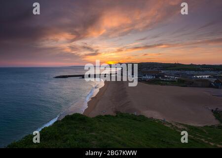 West Bay, Dorset, UK.  20th April 2020.  UK Weather.  Sunset at the seaside resort of West Bay in Dorset with the settled weather set to continue this week with rising temperatures.  Picture Credit: Graham Hunt/Alamy Live News Stock Photo