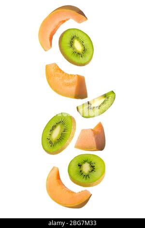 Falling kiwi and melon isolated on white background. Stock Photo