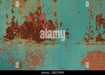 Rust on a painted metal surface. Peeling old paint on gate background. Texture of cracked blue paint and rust on a metal sheet Stock Photo