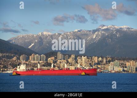 Oil Tanker Burrard Inlet Vancouver. An oil tanker escorted by tug boats in Burrard Inlet. Vancouver, British Columbia, Canada. Stock Photo