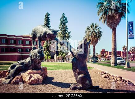 A playful bronze sculpture of Wildcats, the mascot of the University of Arizona on the grounds of campus in Tucson, AZ Stock Photo