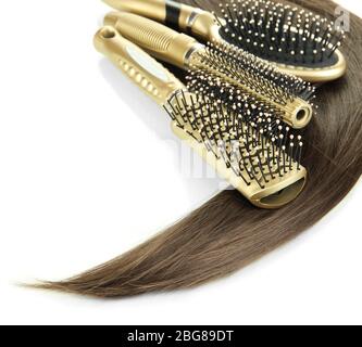 Shiny brown hair with combs isolated on white Stock Photo