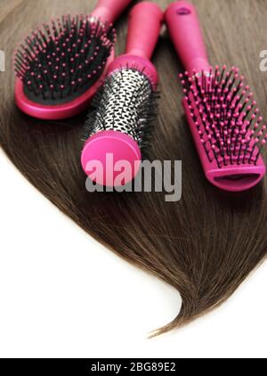 Shiny brown hair with combs isolated on white Stock Photo