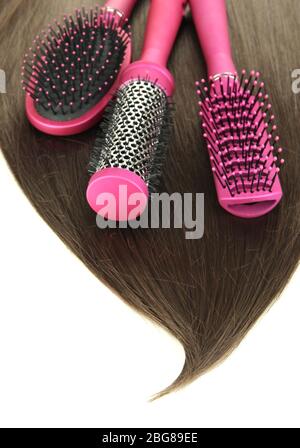 Shiny brown hair with combs isolated on white Stock Photo