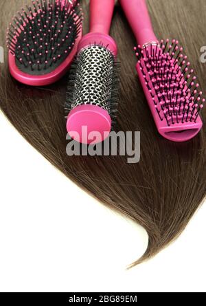 Shiny brown hair with combs isolated on white Stock Photo