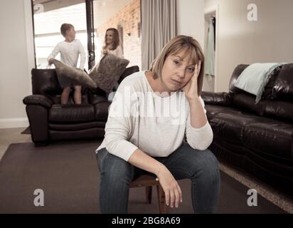 COVID-19 Isolation and mental health. Stressed out parents struggling with having the children at home during Coronavirus lockdown. Overwhelmed mother Stock Photo