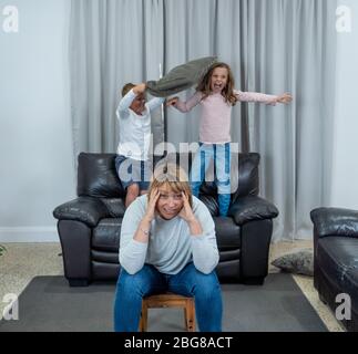 COVID-19 Isolation and mental health. Stressed out parents struggling with having the children at home during Coronavirus lockdown. Overwhelmed mother Stock Photo