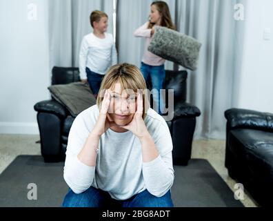 COVID-19 Isolation and mental health. Stressed out parents struggling with having the children at home during Coronavirus lockdown. Overwhelmed mother Stock Photo