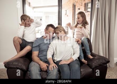 COVID-19 Isolation and mental health. Stressed out parents struggling with having the children at home during Coronavirus lockdown. Mother and father Stock Photo