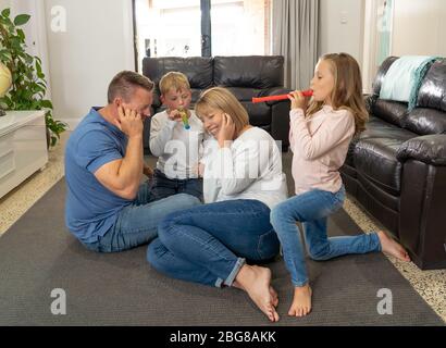 COVID-19 Isolation and mental health. Stressed out parents struggling with having the children at home during Coronavirus lockdown. Mother and father Stock Photo