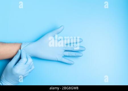 Surgeon putting medical gloves on Stock Photo