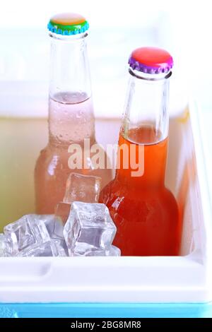 Drinks in glass bottles in mini fridge close up Stock Photo