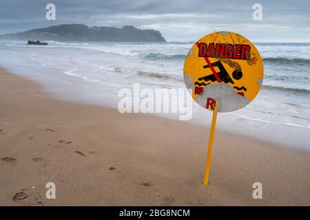 Danger sign on Hot Water Beach, Hahei, Coromandel Peninsula, North Island, New Zealand Stock Photo