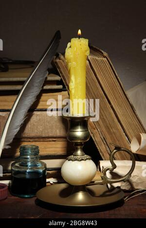Old candle on table in room Stock Photo