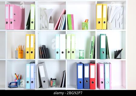White office shelves with folders and different stationery, close up Stock Photo