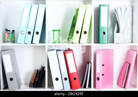 White office shelves with folders and different stationery, close up Stock Photo