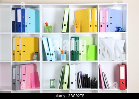 White office shelves with folders and different stationery, close up Stock Photo