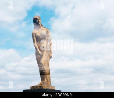 Double exposure photo of Tatsuko golden statue at Lake Tazawa, Akita, Japan. Stock Photo