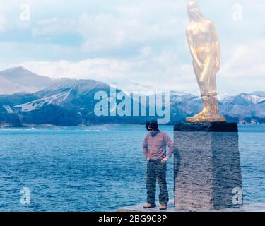 Double exposure photo of Tatsuko golden statue at Lake Tazawa, Akita, Japan. Stock Photo