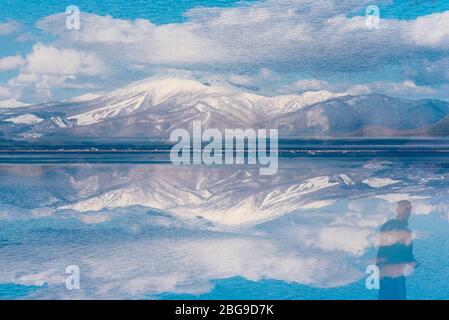 Double exposure photo of Tatsuko golden statue at Lake Tazawa, Akita, Japan. Stock Photo