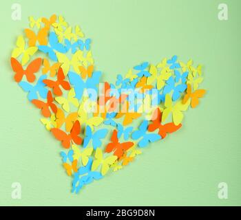 Paper butterflies on green wall Stock Photo