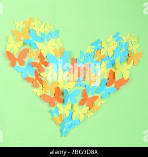 Paper butterflies on green wall Stock Photo