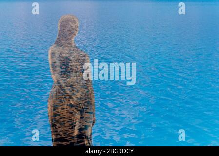 Double exposure photo of Tatsuko golden statue at Lake Tazawa, Akita, Japan. Stock Photo