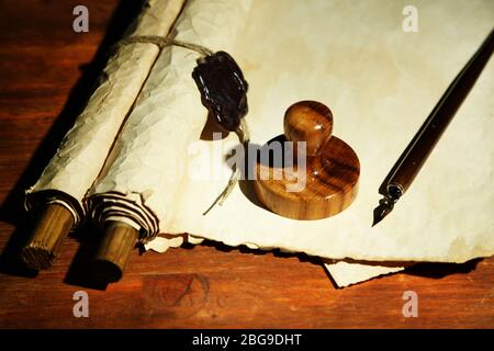 Wooden stamp, books and old papers on wooden table Stock Photo