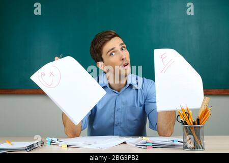 Young teacher review tests in school classroom Stock Photo