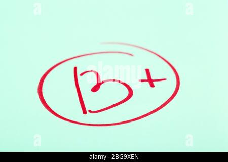 Grade B+ written on an exam paper Stock Photo