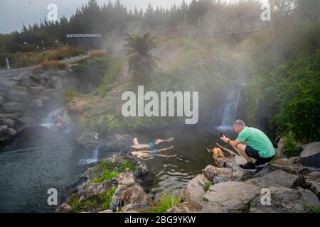 Hot water from Otumuheke Stream running into Waikato River at Spa Thermal Park, Taupo, North Island, New Zealand Stock Photo