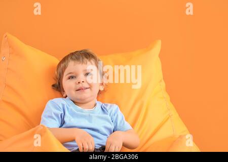 Cute little boy on color background Stock Photo