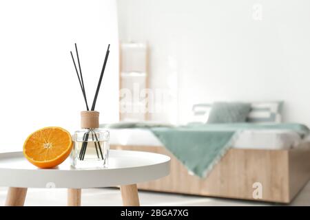 Reed diffuser on table in bedroom Stock Photo